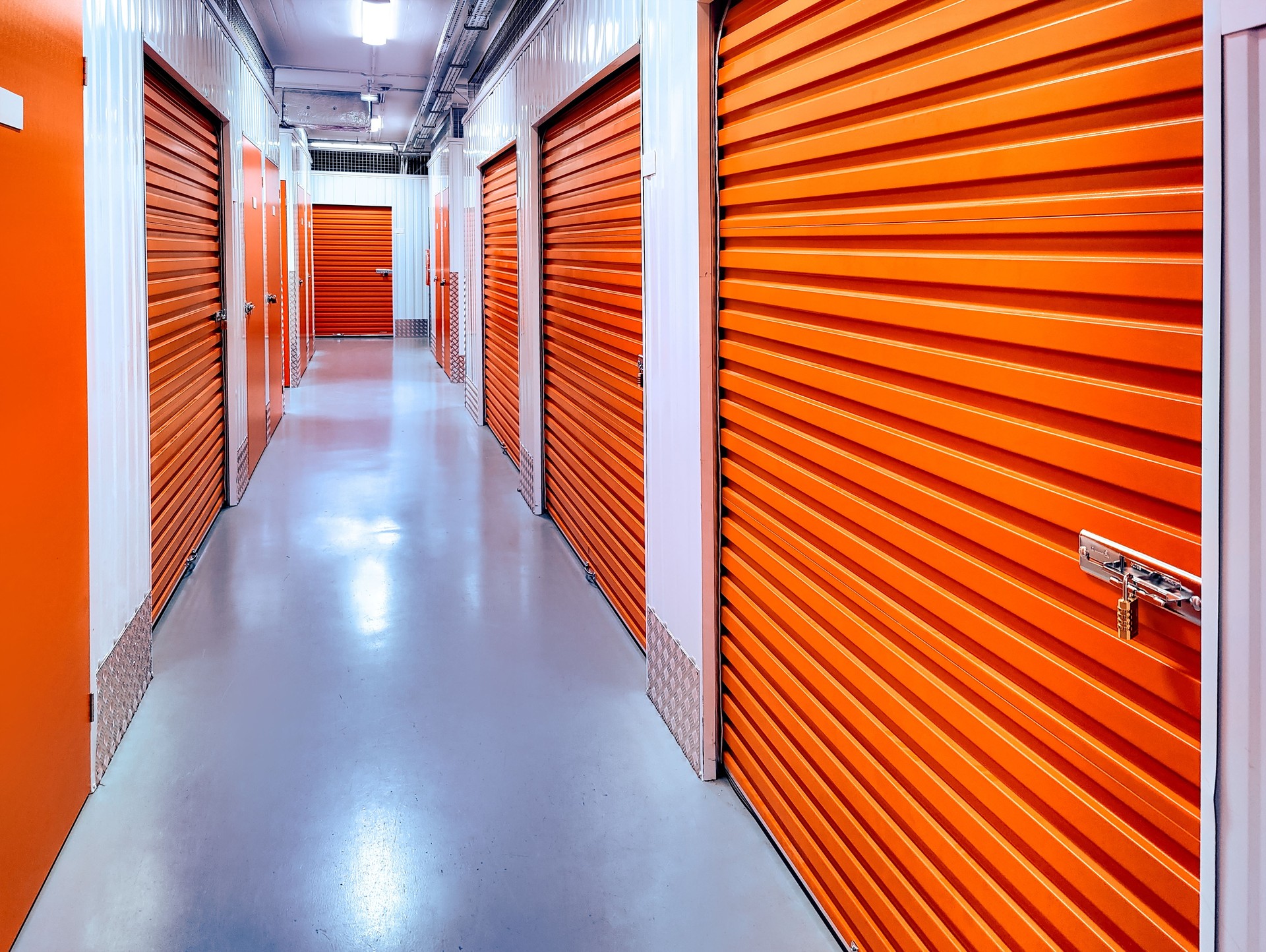 Indoor climate-controlled storage building with orange roll-up doors Indoor climate-controlled storage building with orange roll-up doors